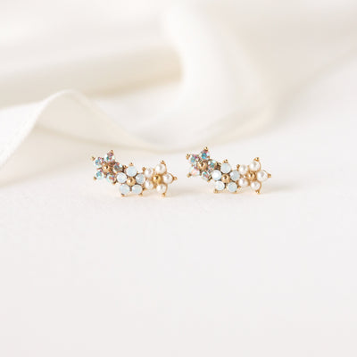 Floral climber earrings in white by Lover's Tempo, close-up